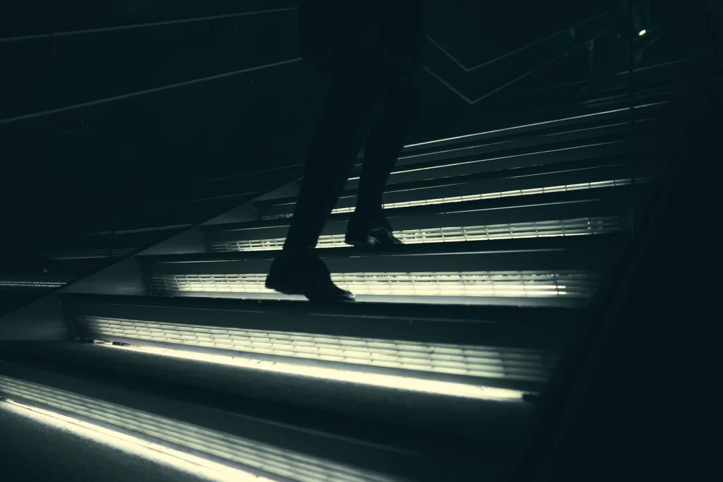 Business owner walking up illuminated steps