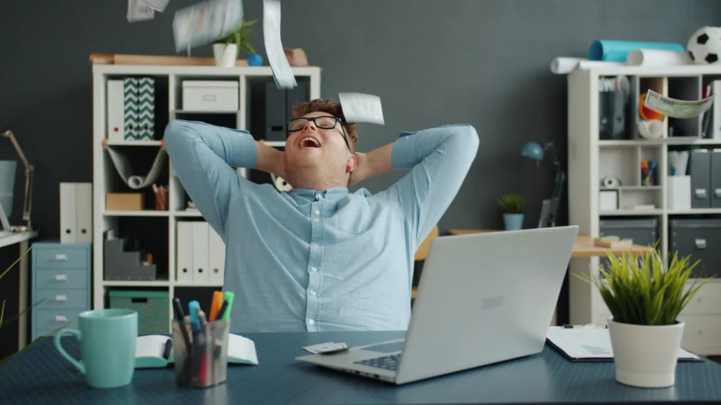 Business owner feeling relieved at desk